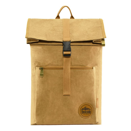 A brown kraft paper laptop backpack with a fold-over top, zippered front pocket, and a logo patch.