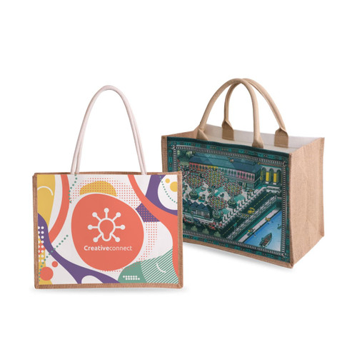 Two tote bags are displayed: one is canvas with a colourful design and logo, while the other is jute with a detailed illustrated scene.