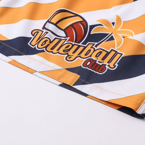 Sublimated board shorts in orange, navy, and white with a volleyball and palm tree design, featuring a logo.