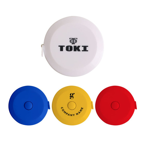 A set of four round tape measures in white, blue, yellow, and red, with one featuring a logo.