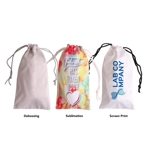 A trio of drawstring pouches in white, colourful patterned, and beige; each featuring different printing methods and a logo.