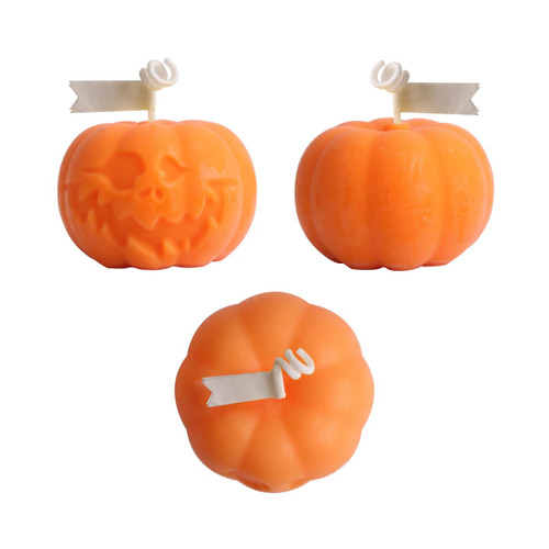 Orange pumpkin-shaped candles with white decorative tags, featuring a smiling and a spooky face design.