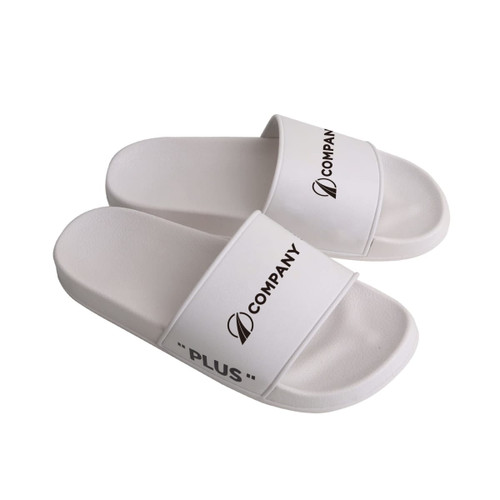 White PVC slides with a wide strap, featuring branding and a minimalist design.