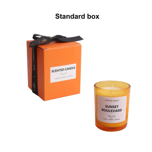 A 3.5oz glass scented candle in a vibrant orange box, featuring a label with "Sunset Boulevard."