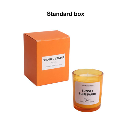 A 3.5oz glass candle in an orange box, featuring a white label and a warm yellow-orange candle.