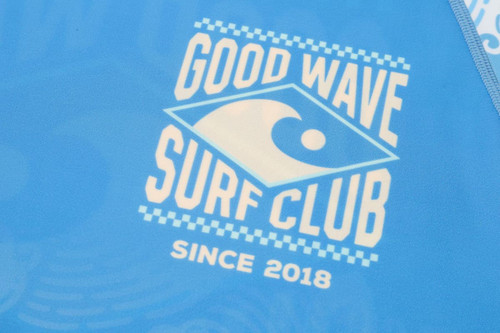 A blue rashie with a logo featuring wave and text detailing, designed for UPF 50+ sun protection.