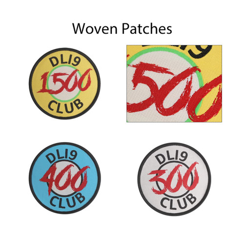 Four custom woven patches in various colours, featuring circular designs with different numerical values and a logo.