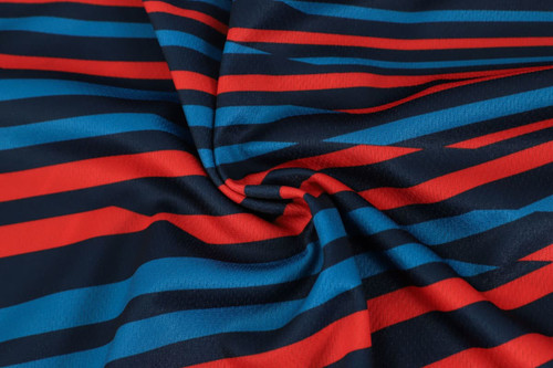 A fabric with red and blue horizontal stripes, showcasing a smooth, polyester texture.
