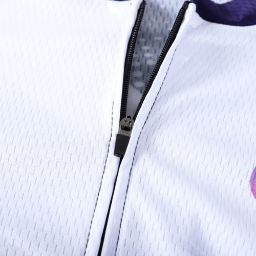 A close-up of a unisex cycling jersey featuring a stand collar, short sleeves, and a zip, with a white and purple design.