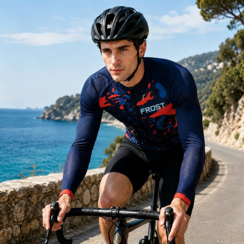 A men's long sleeve cycling jersey in navy blue with vibrant red and blue splashes, featuring a logo, worn by a cyclist.