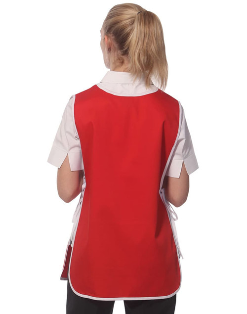 A ladies' smock in red with a back view, featuring a white collar and tied sides. It has a logo on the fabric.