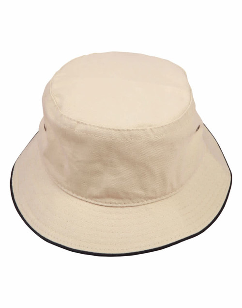 A beige bucket hat featuring a contrast black trim and a small logo on the side.