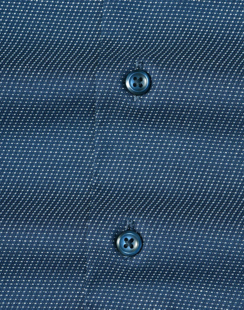 Men's long-sleeve button-up shirt in navy with a pin dot pattern and contrasting buttons. Features branding.
