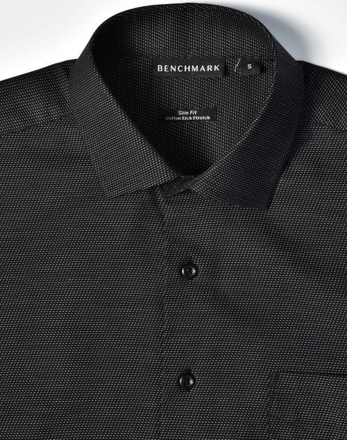 A black pin dot short-sleeve button-up shirt featuring a collar, buttons, and a pocket, with a logo on the label.