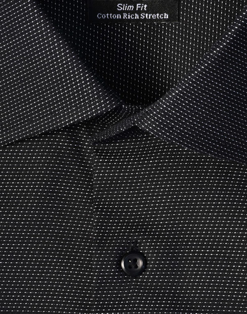A black slim fit button-up shirt with a pin dot pattern and a collar, featuring a logo tag inside.
