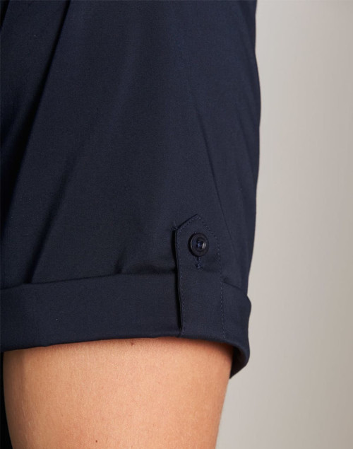A close-up of a navy men's short sleeve military shirt featuring a buttoned cuff detail.