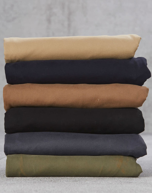 A stack of folded chino pants in various colours: beige, navy, brown, black, dark grey, and olive green.