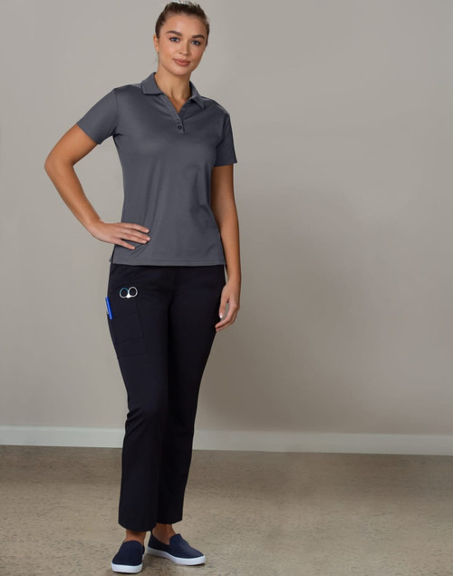 Ladies' utility cargo pants in black, paired with a grey polo shirt, displayed on a model standing against a plain background.