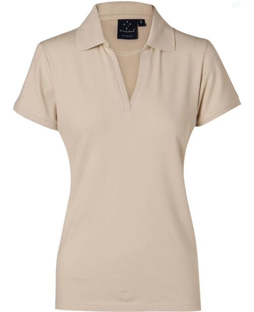 A beige ladies' polo shirt featuring a collar and a logo. Ideal for casual or sporty wear.