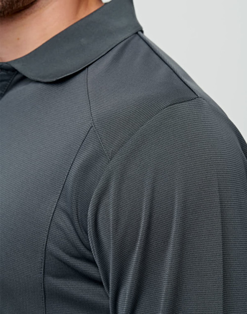 A close-up of a dark grey long-sleeve polo shirt featuring textured fabric and a collar. It has a logo on the chest area.