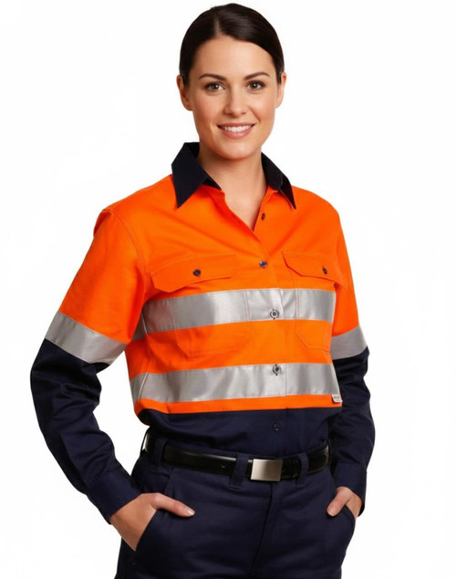 A women's long-sleeve safety shirt in bright orange with silver reflective tape and navy blue accents. Features a logo.