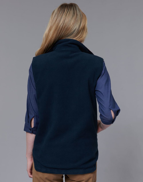 A navy reversible safety vest with a snug collar, shown from the back, paired with a blue shirt underneath.