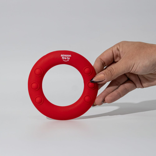 A red silicone wrist disc with a circular design and buttons, featuring a branding logo.