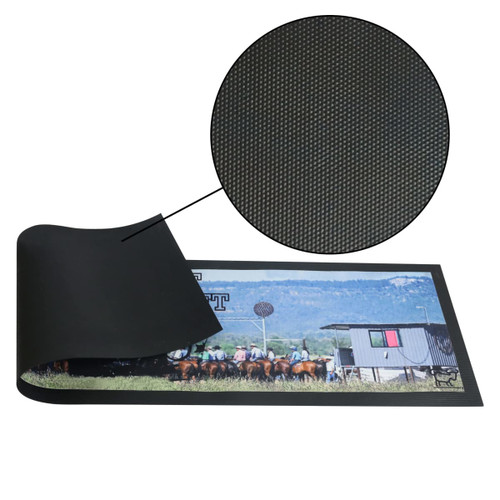 A black bar runner counter mat with a textured surface and a printed image of horses and a barn.
