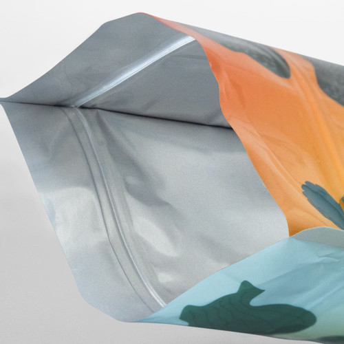 A large foil stand-up pouch in vibrant colours, featuring a printed design and a silver interior. It has a logo on the exterior.