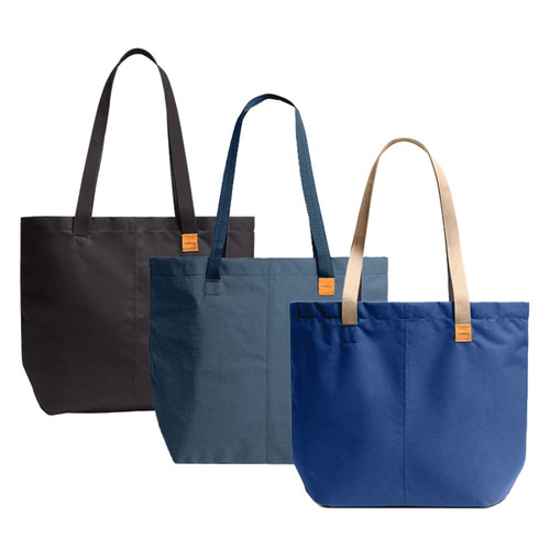 Three tote bags in black, dark blue, and light blue, featuring different strap colours and a logo.