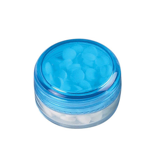 A screw lid mint jar with a transparent base and a blue lid, containing round white sugar-free mints.