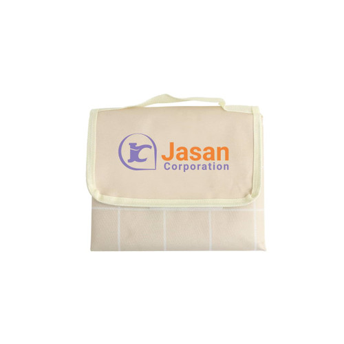A medium picnic blanket in cream with a grid pattern and a logo on the front, featuring a carry handle.