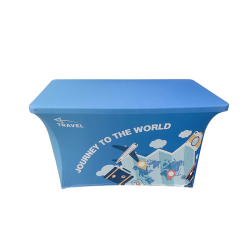 A blue stretch table cover with an open back, featuring travel-themed designs and a logo.