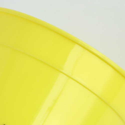 A yellow plastic stadium cup with a glossy finish and a logo on the surface.