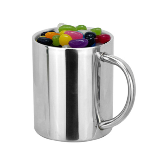 A metallic silver coffee mug filled with colourful jelly beans in various shades. The mug has a sturdy handle.