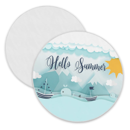 A round beach towel featuring a light blue design with boats, whales, mountains, clouds, and a sun. It includes a logo.