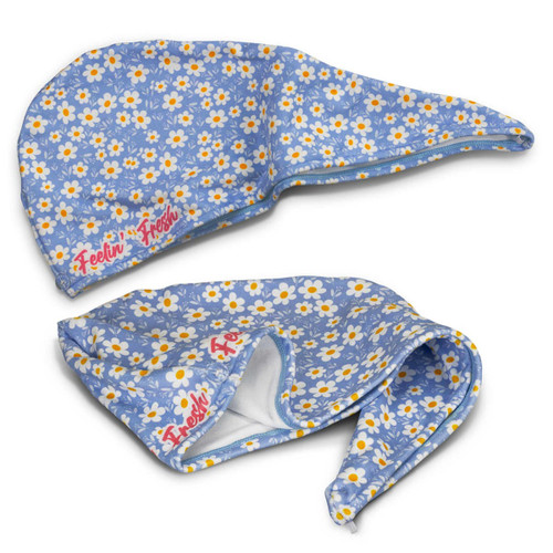 A blue floral hair towel with a pointed hood and a logo, featuring white daisies and yellow accents.
