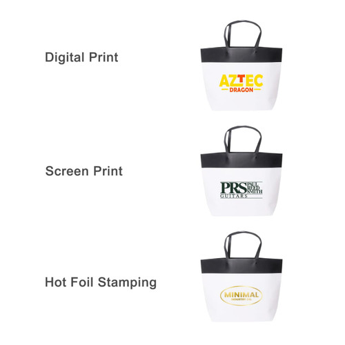 A small black and white boutique paper bag with a handle, featuring different printing styles and designs.