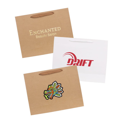 Three paper bags with fabric flat handles, featuring various designs and colours, including a logo and decorative prints.