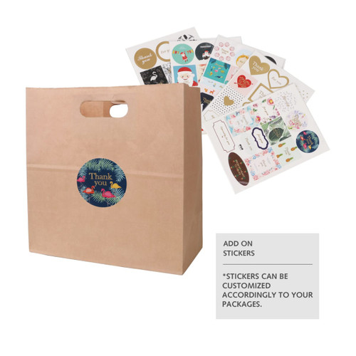 A brown kraft paper bag with a handle, featuring a circular logo and assorted decorative stickers beside it.