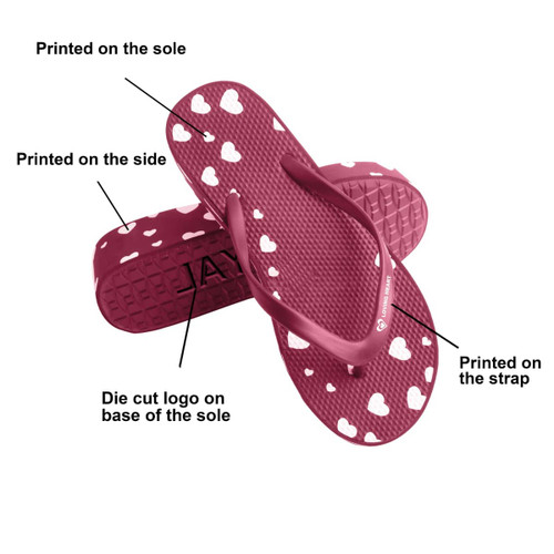 Maroon thongs featuring heart patterns, with a die-cut logo on the sole and printed details on the side and strap.