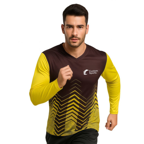 A man in a brown and yellow long-sleeve V-neck sports shirt with a logo, featuring a chevron pattern.