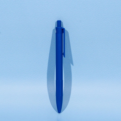 A blue plastic ballpoint pen with a clip, set against a light blue background.