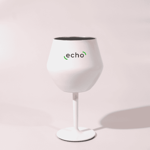 A white Shiraz detachable wine glass with a black interior and a stand, featuring a logo.