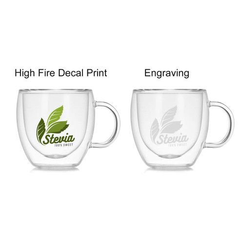 A double wall mug in clear glass featuring a green leaf design and an engraved option, with a handle on the side.