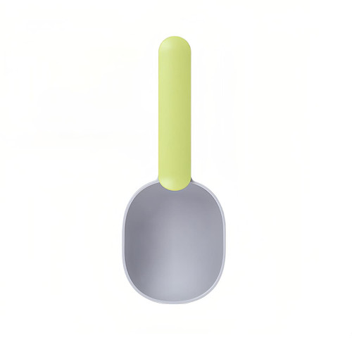 A 2 in 1 pet food scoop with a light green handle and a grey scoop head, featuring a simple design and a logo.