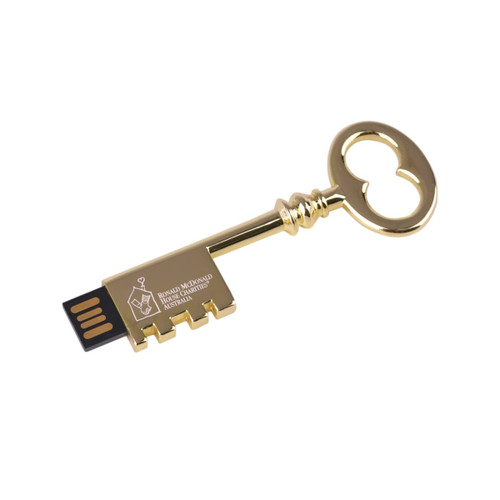 A gold retro key-shaped flash drive with a USB connector and a logo on its surface.
