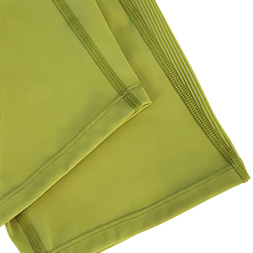 High-waisted elastic yoga 1/2 leggings in a vibrant green colour, showcasing smooth fabric and stitching details.