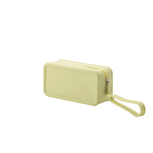 A silicone square cosmetic bag in a soft yellow shade, featuring a zip closure and a wrist strap.