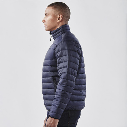 A navy puffer jacket with a high collar and side zip pockets, displayed on a male model.